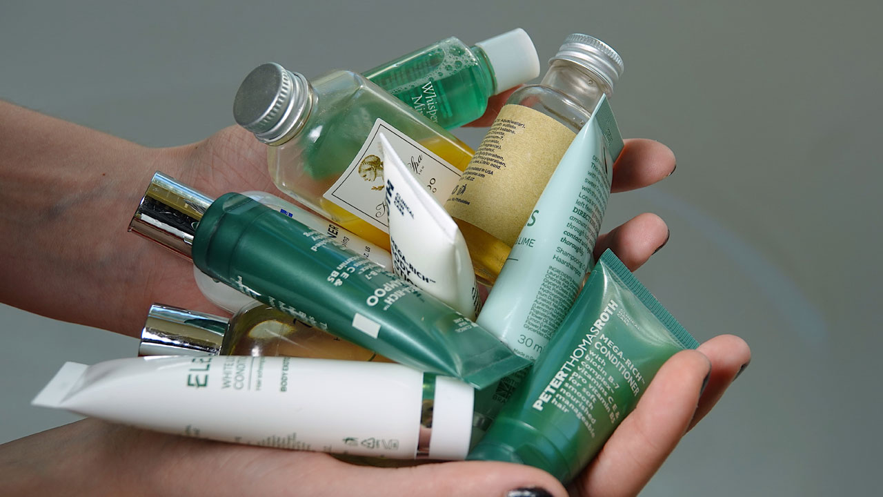 Photo of someone holding various single-use personal care products.